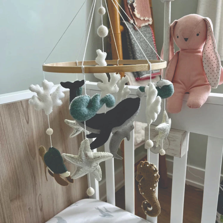 sea-baby-mobile-next-to-pink-toy