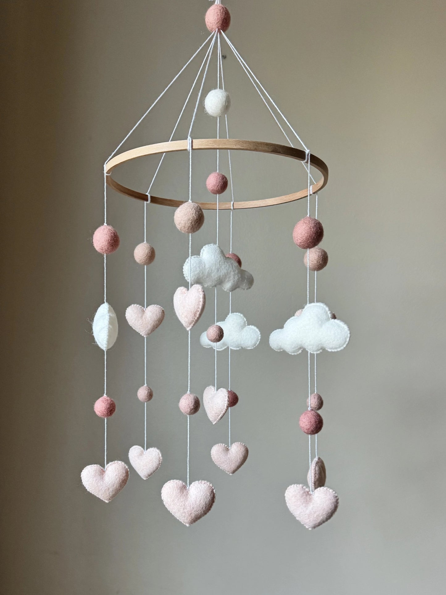 handmade cloud baby mobile. Soft felt clouds, hearts, and pom-poms create the perfect gender-neutral nursery décor. Ideal gift for baby showers and newborns.