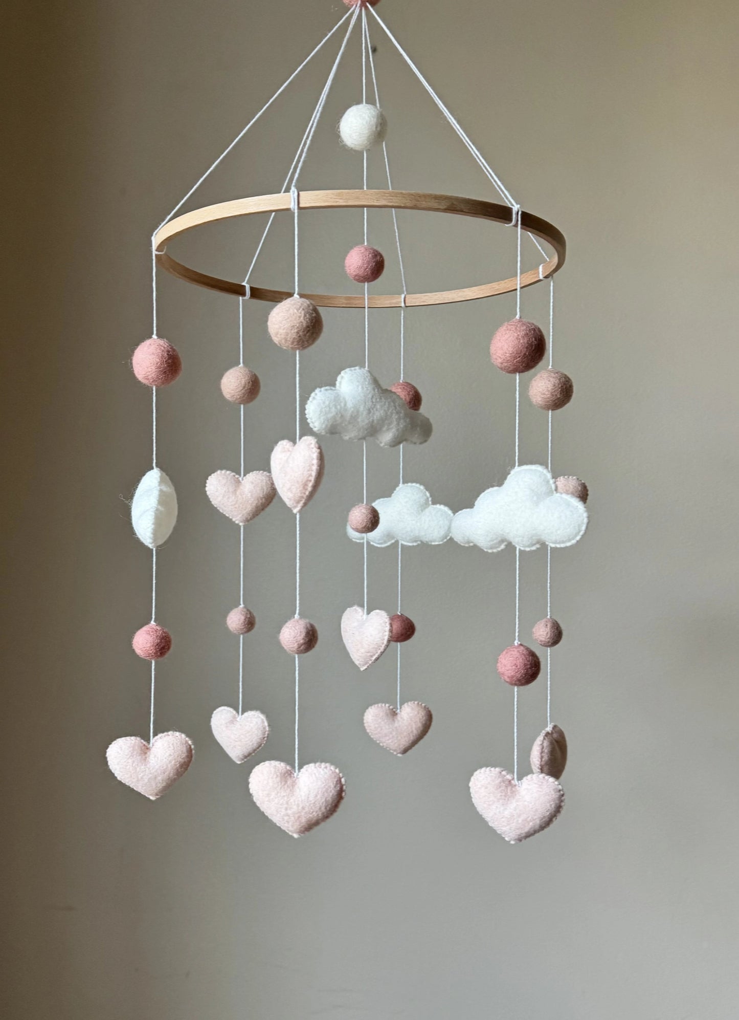 handmade cloud baby mobile. Soft felt clouds, hearts, and pom-poms create the perfect gender-neutral nursery décor. Ideal gift for baby showers and newborns.