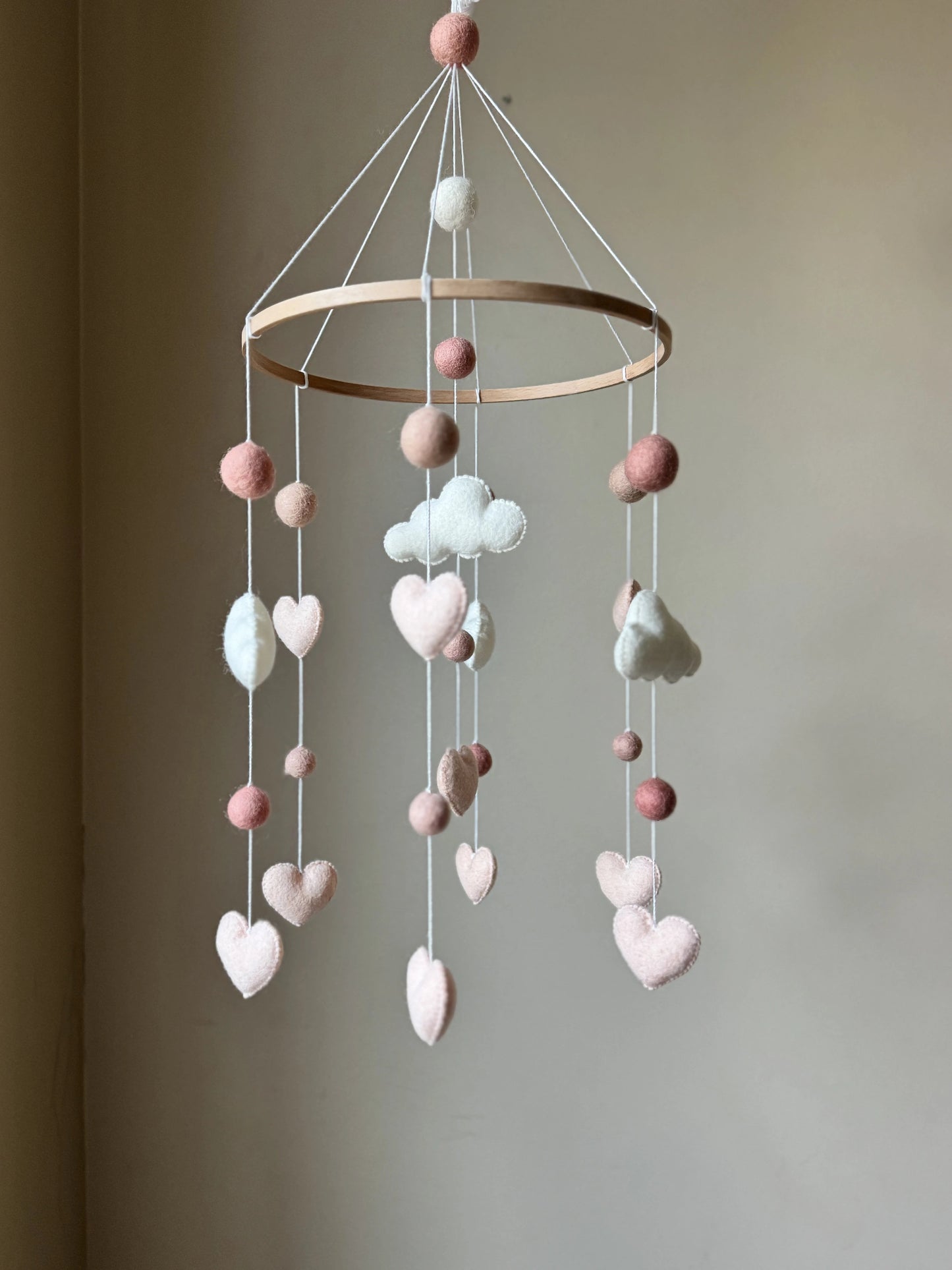 handmade cloud baby mobile. Soft felt clouds, hearts, and pom-poms create the perfect gender-neutral nursery décor. Ideal gift for baby showers and newborns.
