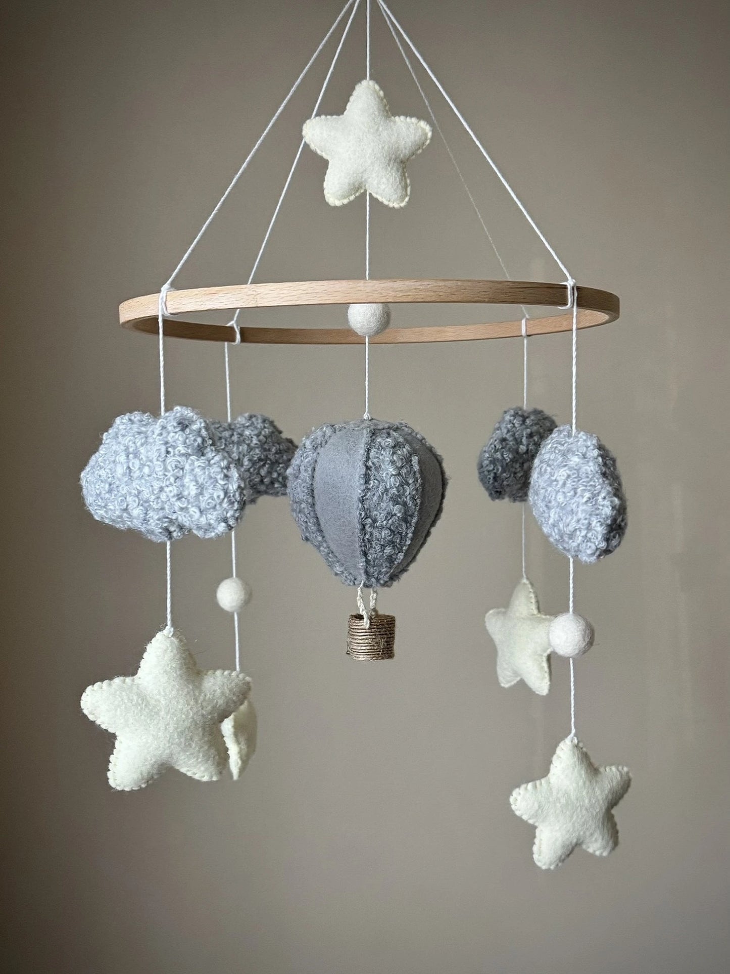 Decorative hanging mobile with stars, clouds, and a hot air balloon