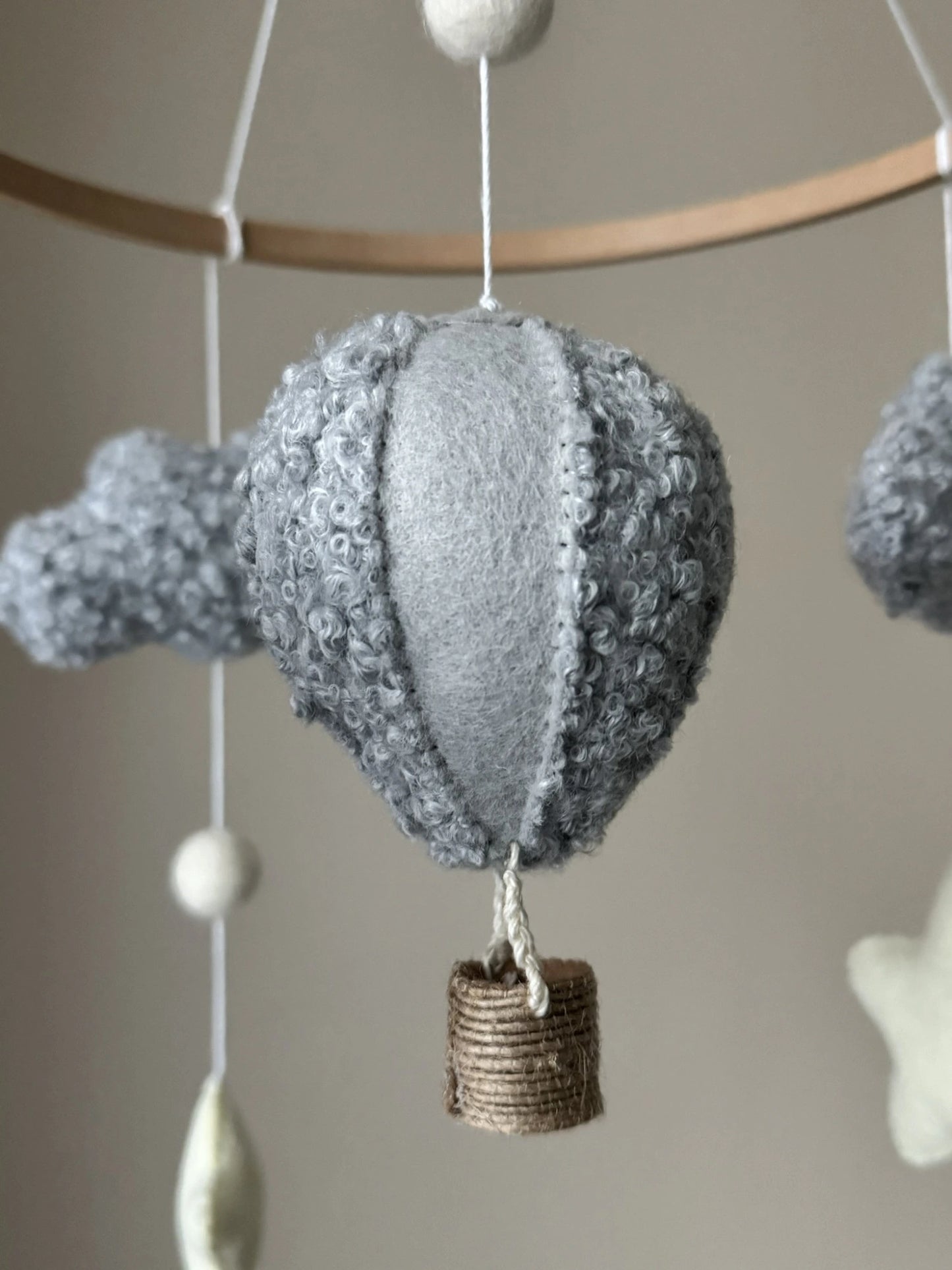 Decorative hot air balloon mobile with textured gray balloon and brown basket