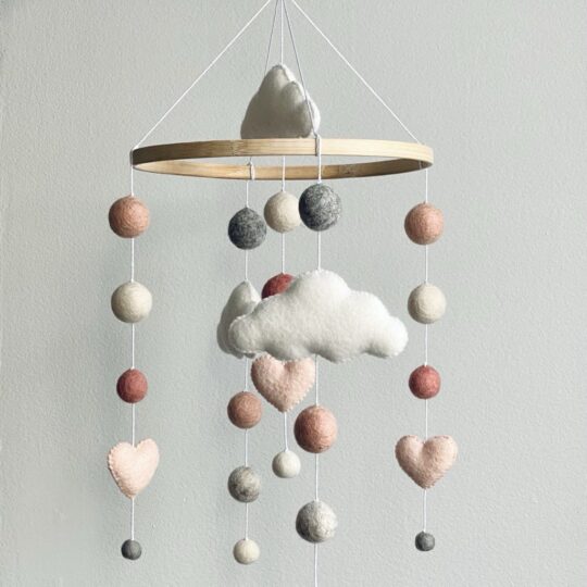 Felt balls mobile with hearts and clouds