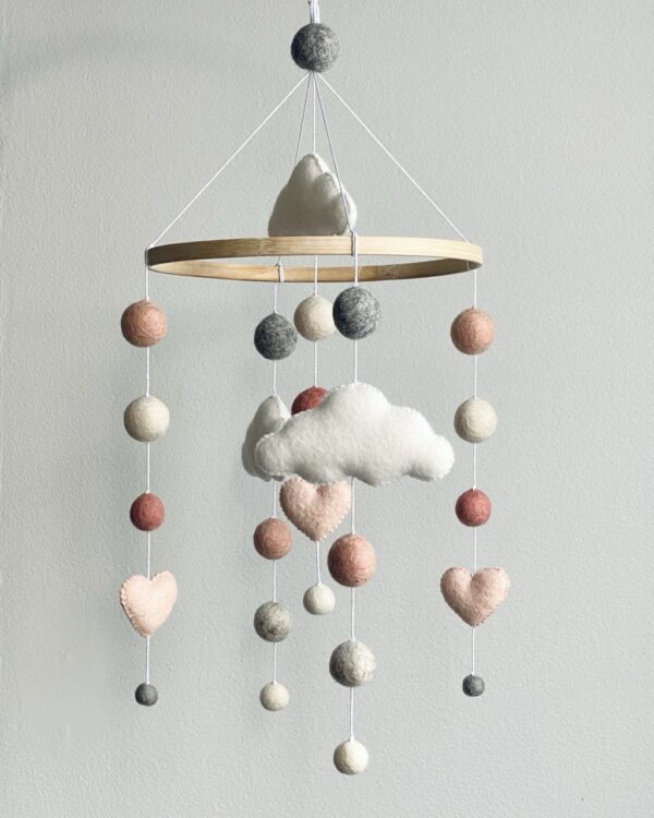 Felt balls mobile with hearts and clouds